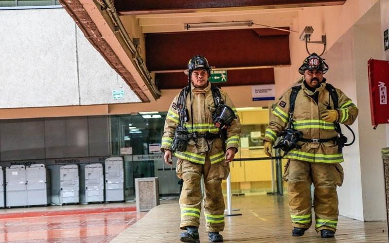 Firefighters walking together inside a building