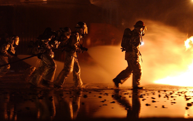 Firefighters in motion, putting out a wildfire